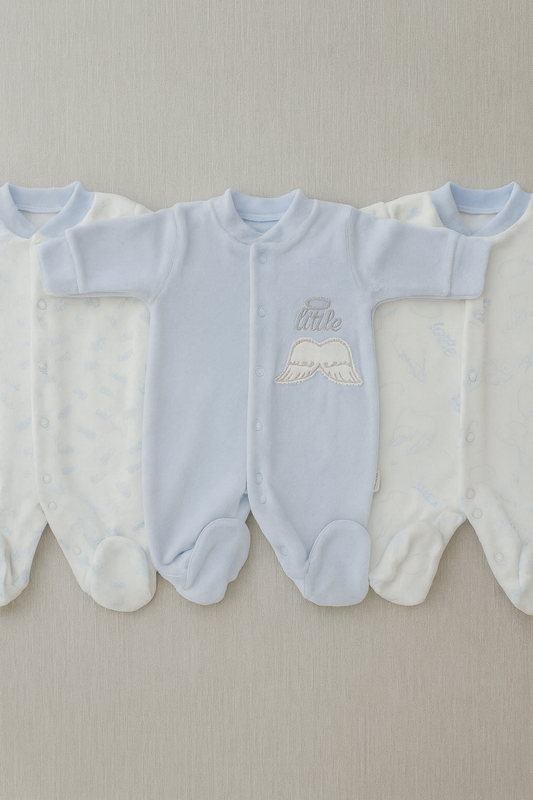 Three light blue baby rompers with embroidered text on a neutral background