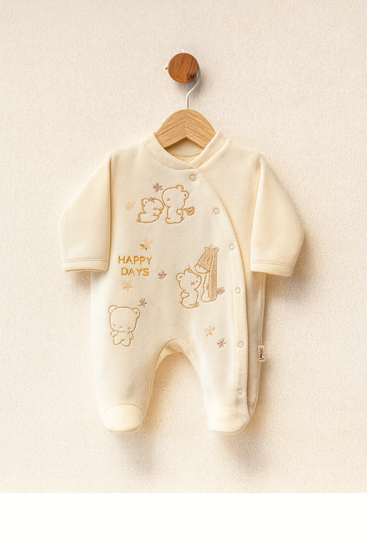 Baby onesie with teddy bear designs and 'Happy Days' text on a wooden hanger against a beige background