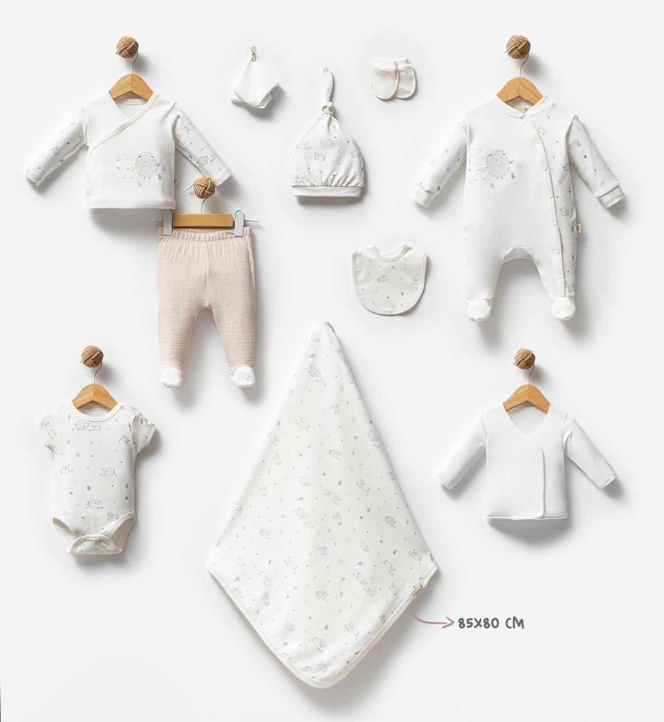 Collection of baby clothes and accessories on a white background